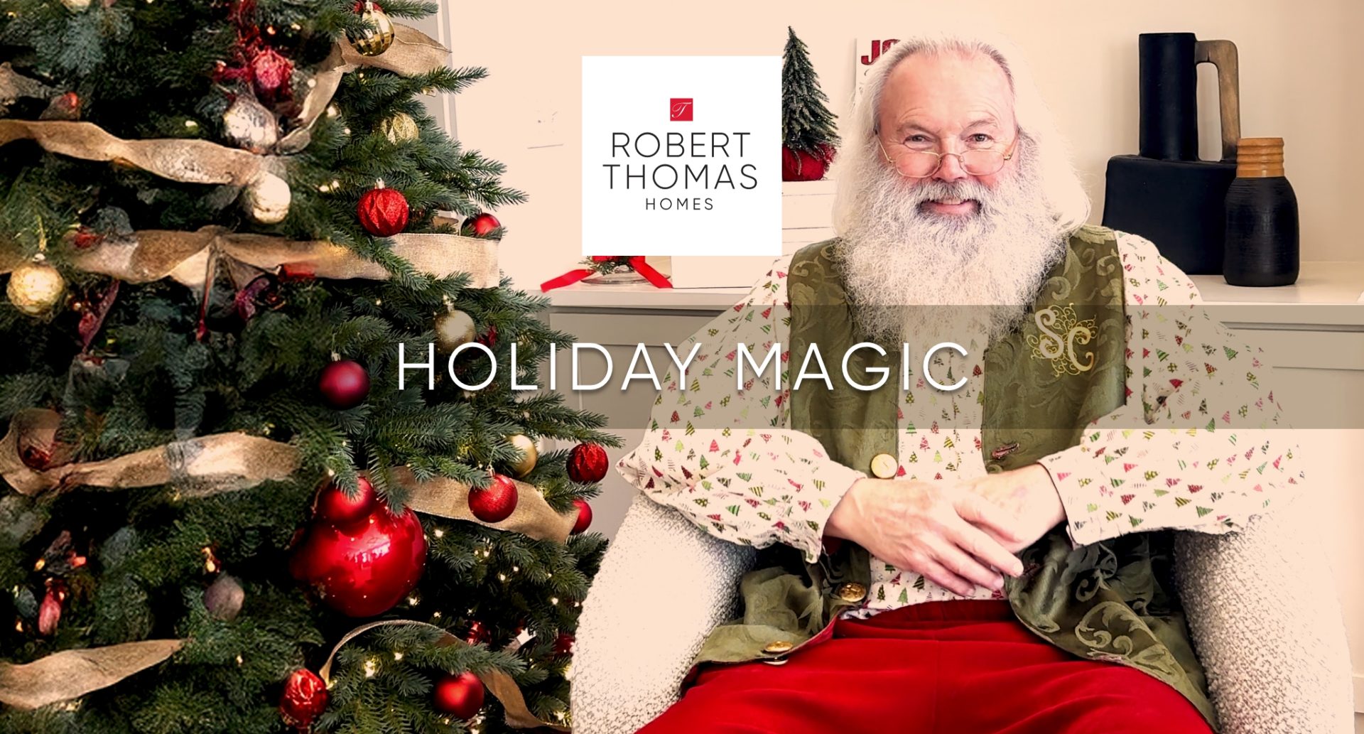 Santa sitting by the tree.