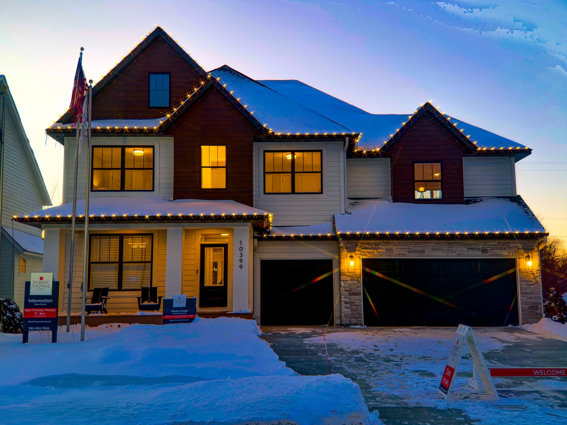 Wesley Model, Evanswood, Maple Grove - twilight photo showing architcture outlined with warm white christmas lights along roofline of first and second floors.